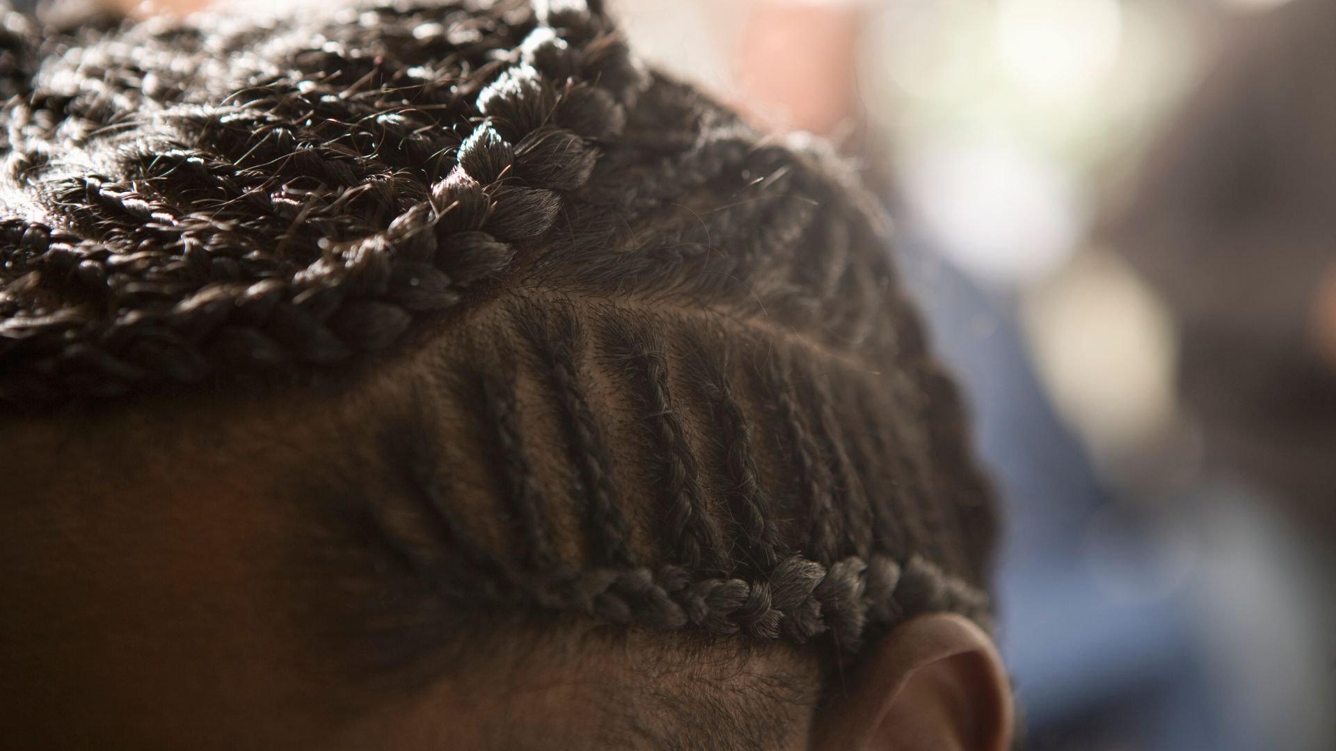 Close-up of tightly braided hair with intricate cornrow pattern