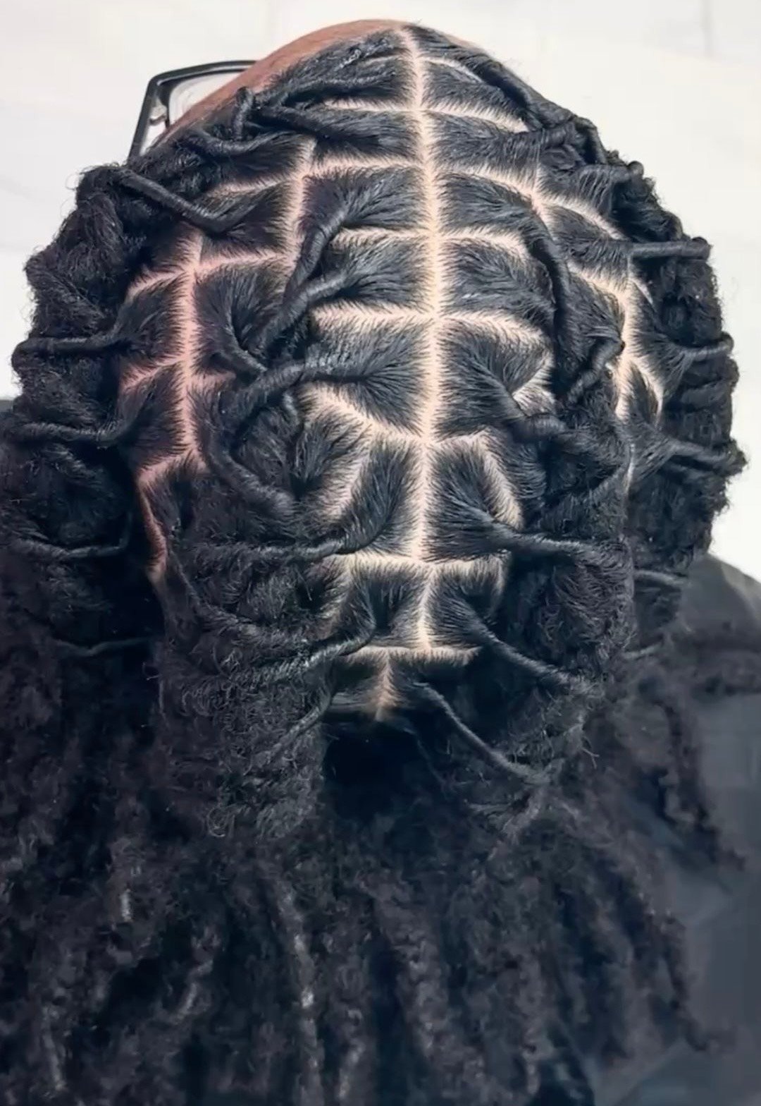 Intricate geometric braided hairstyle with symmetrical black and gray pattern